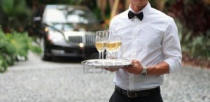 12573412-tuxedo-dressed-waiter-serving-champagne